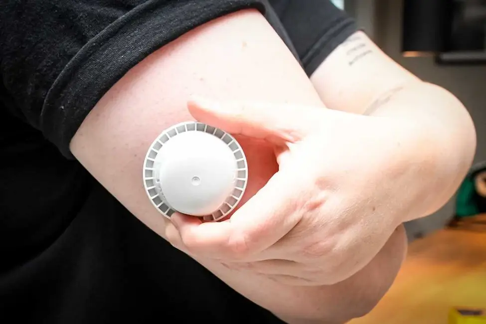 یک تصویر توصیفی نشان میدهد دستگاه نصب حسگر گلوکز Abbott Freestyle Libre 3 Plus بر روی بازوی یک بیمار در روز پنجشنبه.